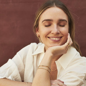 Model wearing the 14k semi-hollow gold link chain charm bracelet 