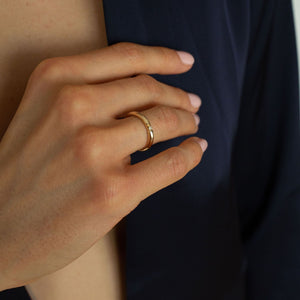 Model wearing 14k gold ring with star-set diamond