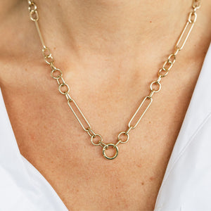 Model wearing chunky mixed link gold charm necklace 