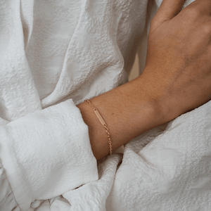 Model wearing 14k gold engravable nameplate bracelet