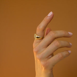 Model wearing 14k solid gold engravable oval signet ring