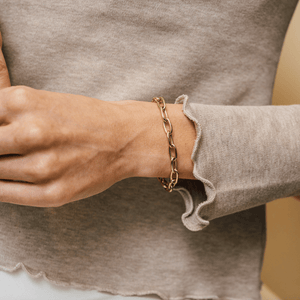 Model wearing 14k gold charm bracelet