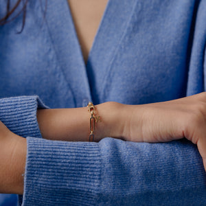 Model wearing 14k solid gold letter "K" charm on a bracelet