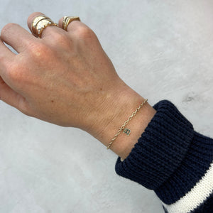 Model wearing 14k solid gold letter "B" charm on bracelet