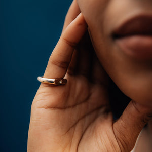 Model wearing the 14k solid gold double sided straight signet-style ring with a baguette diamond and round diamond